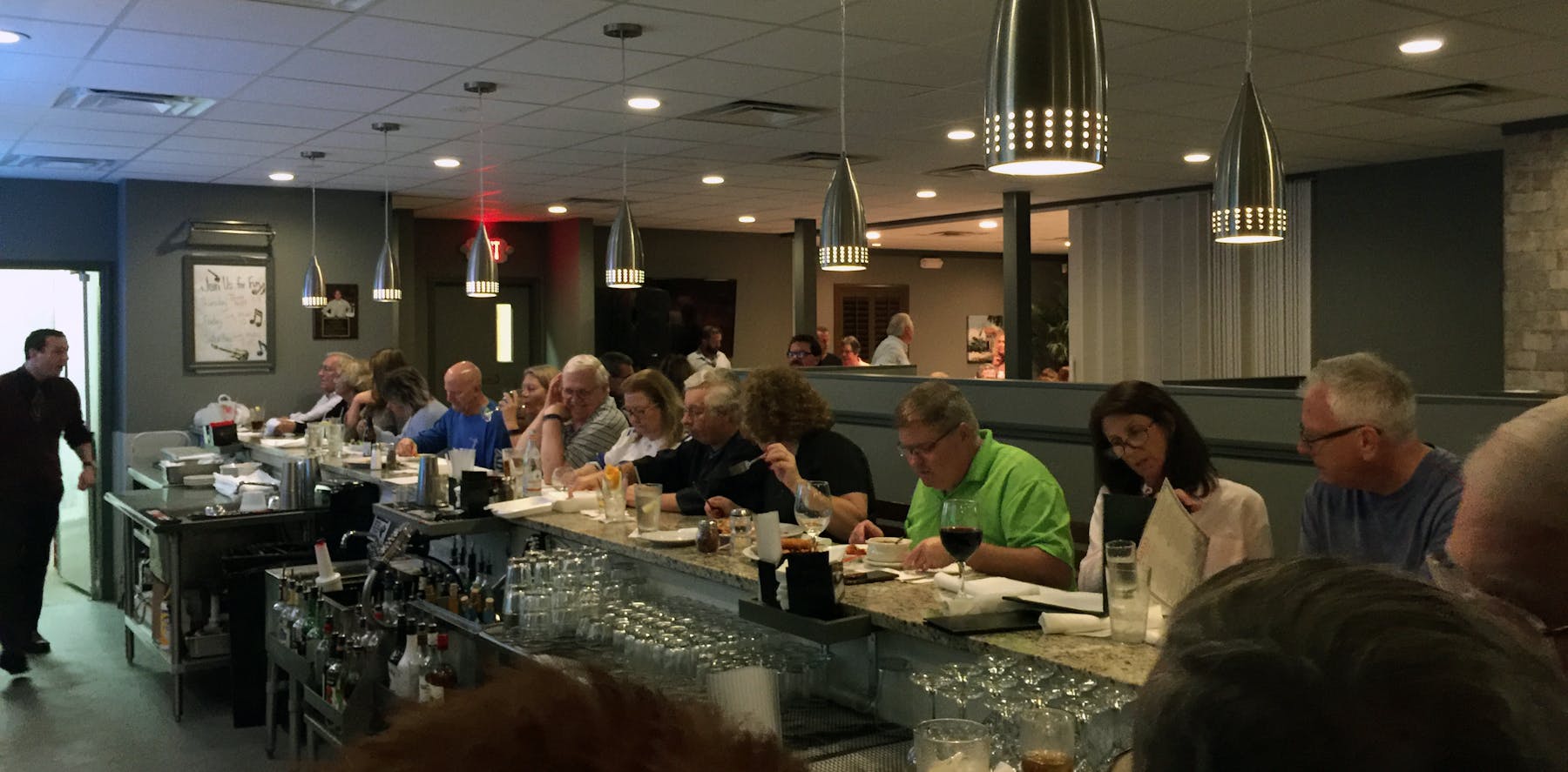 a group of people sitting at a table in a restaurant